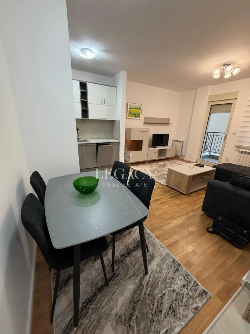 Living room with dining area and adjacent kitchen.