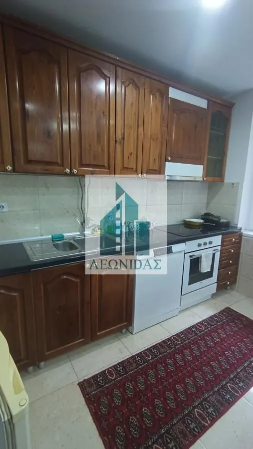 Kitchen with wooden cabinetry, a sink, and built-in appliances.