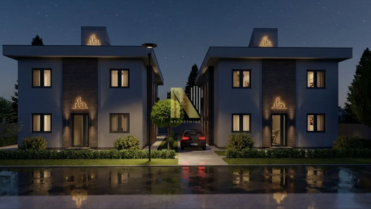 Noćni prikaz eksterijera modernih dvojnih kuća sa osvetljenjem.