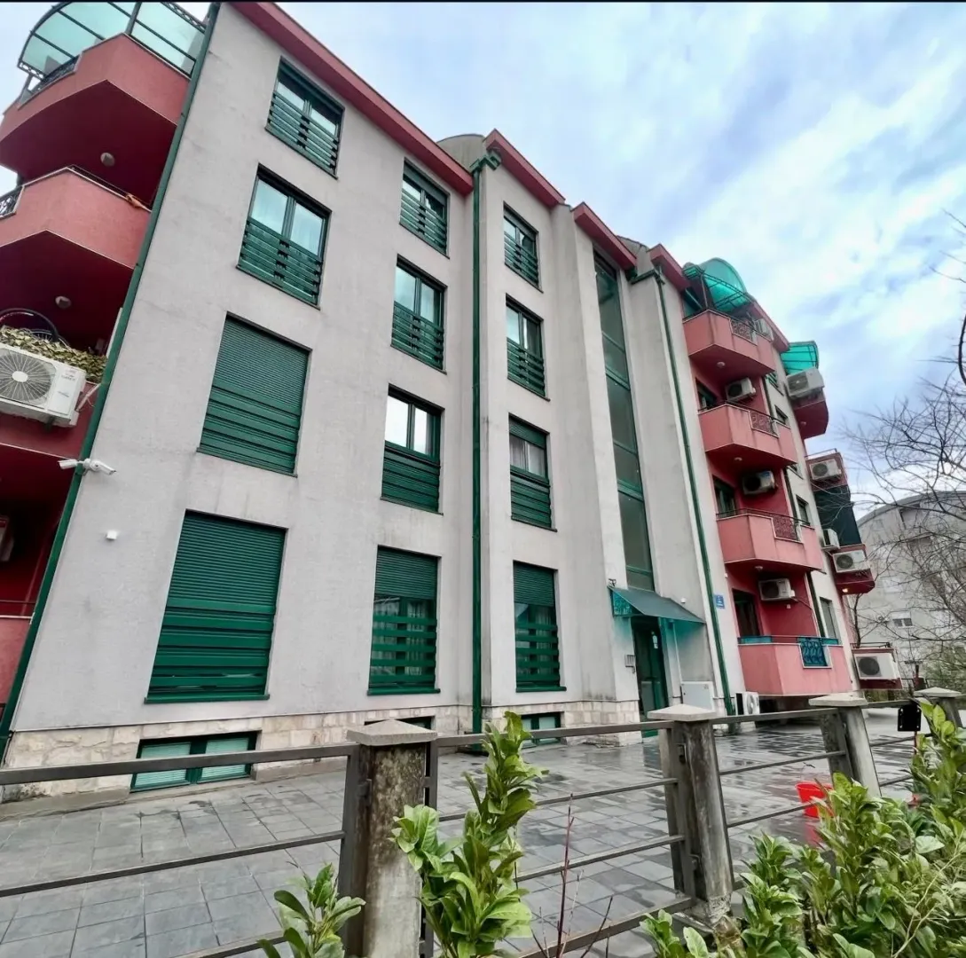 Exterior view of a multi-story residential building with balconies and windows.