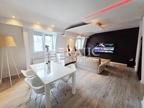 Living room with dining area and modern lighting. - image 3