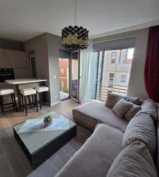 Living room with a sectional sofa, dining area, and access to the terrace. - image 2