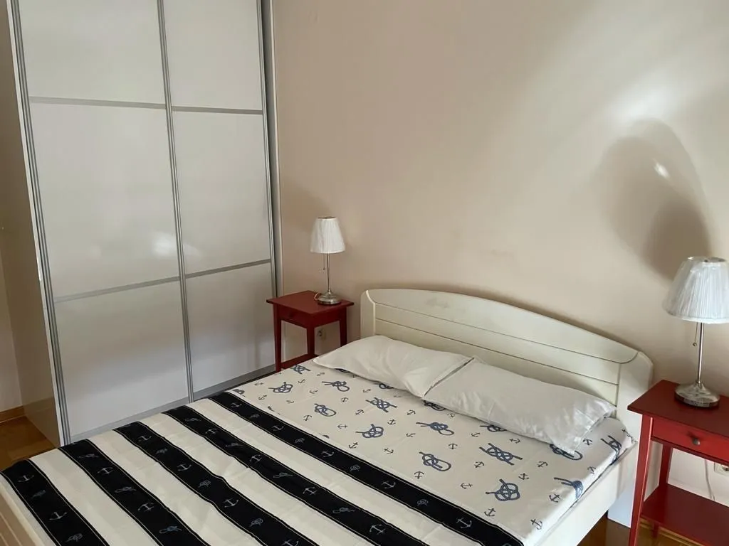 Bedroom featuring a double bed and a large wardrobe.