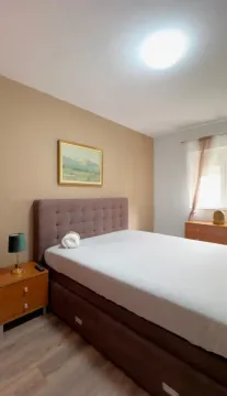 Bedroom with a double bed, nightstand, and a window. - image 8