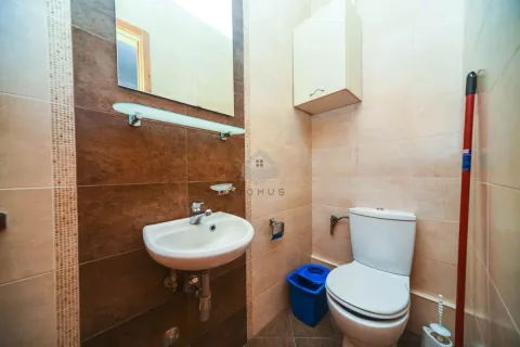 Small bathroom with a washbasin, mirror, and toilet. - image 7