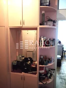 Interior detail showing a built-in wardrobe and shelving in a room. - image 9