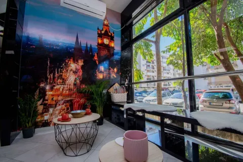 Modernly decorated space with large windows overlooking the street. - image 2