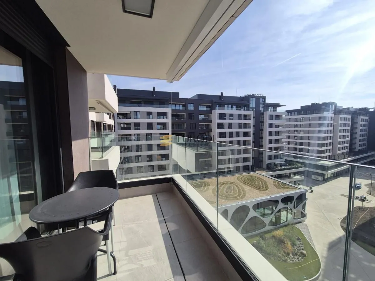 Modern balcony with seating set and a view of the neighborhood.
