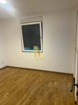 An empty room with white walls and a wooden floor. - image 12