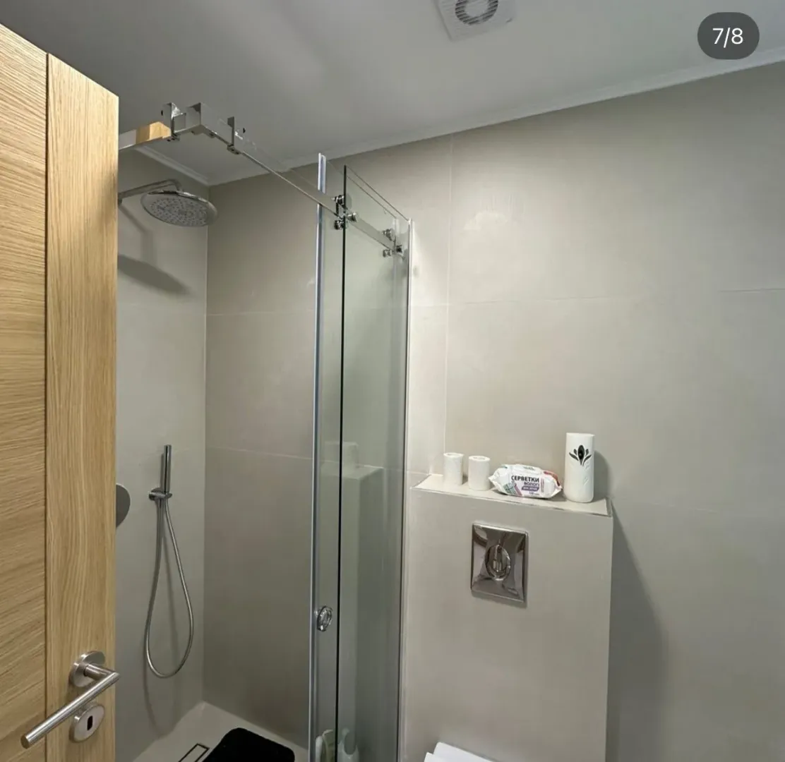 Modern bathroom with a shower cabin and built-in fixtures.