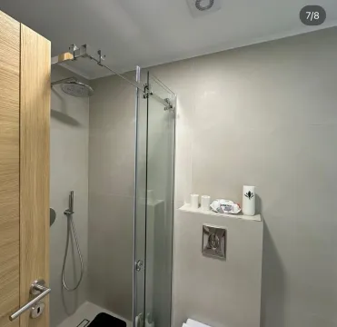 Modern bathroom with a shower cabin and built-in fixtures. - image 6