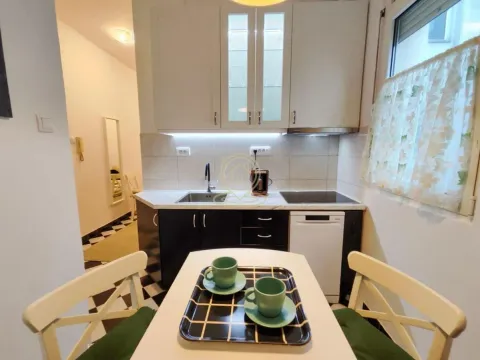 Small equipped kitchen with a dining table and chairs. - image 5