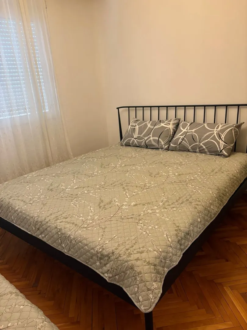 Bedroom with a double bed and wooden flooring.