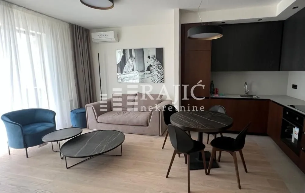 Modern living room with dining area and open-plan kitchen.