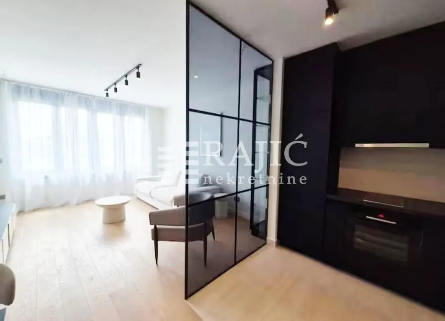 Living room connected to the kitchen with a glass partition panel.