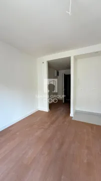 Empty room with wooden flooring and white walls. - image 7