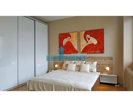 Furnished bedroom with a double bed, wardrobe, and artwork on the wall. - image 7