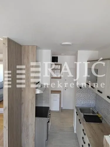 View of a small kitchen and hallway in the apartment.