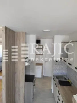 View of a small kitchen and hallway in the apartment. - image 6