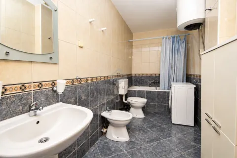 Bathroom equipped with a washbasin, toilet, bidet, bathtub, and washing machine. - image 18