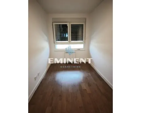 Empty room with hardwood floors and a window. - image 8