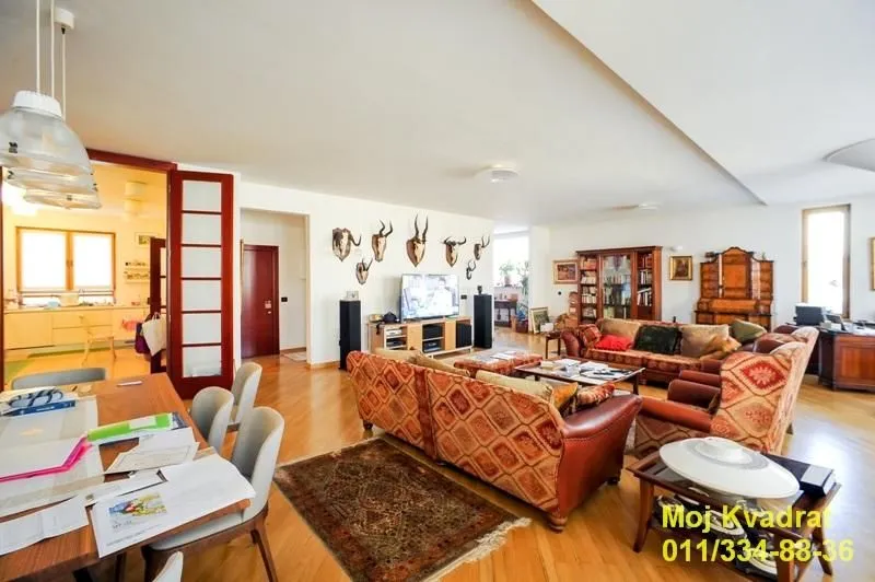 Spacious living room connected with the dining area and seating furniture.