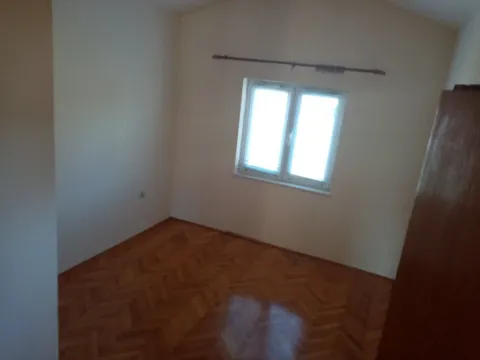 An empty room featuring parquet flooring and a single window. - image 24