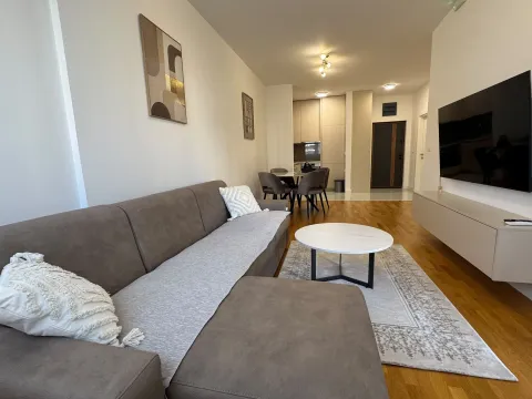 Spacious living room with a sofa and dining area in the background. - image 3