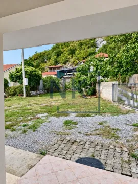 View from a covered area towards the yard and surrounding greenery. - image 5