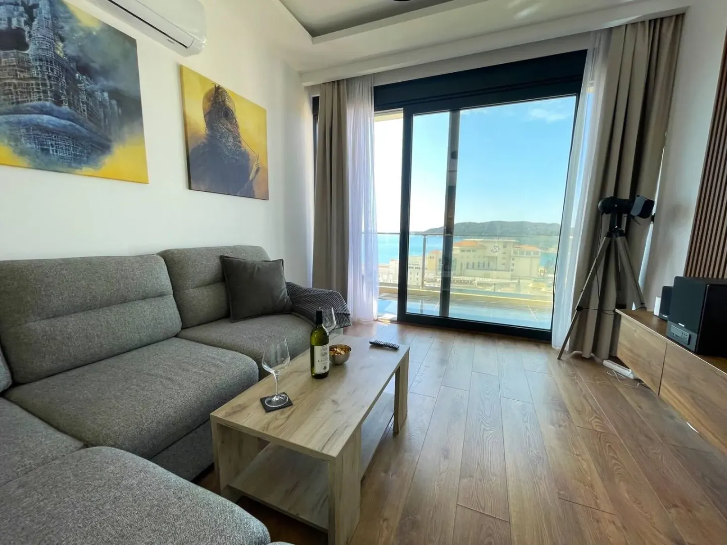 Living room with a sofa, coffee table, and access to a terrace with a sea view.