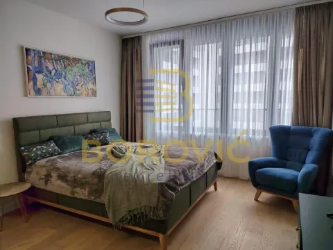 Nameštena spavaća soba sa bračnim krevetom, foteljom i velikim prozorom. - image 7