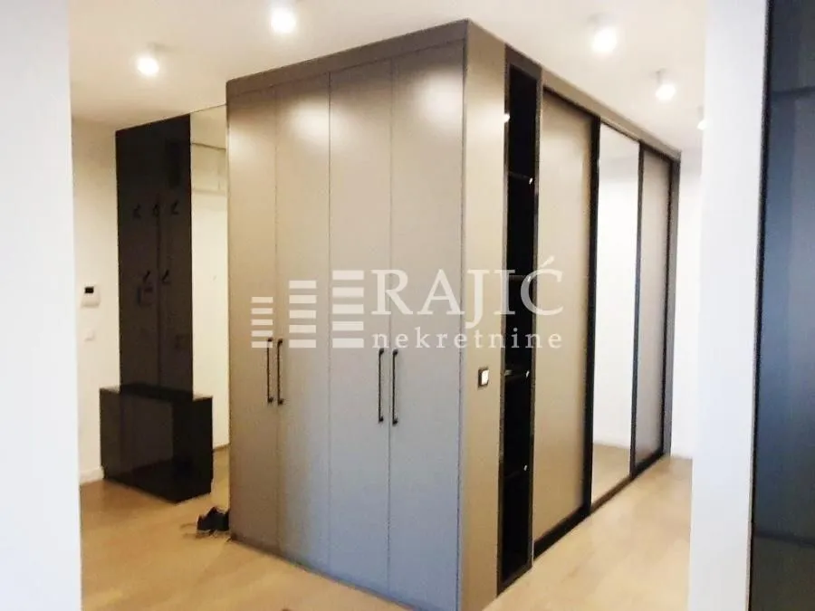 Modern wardrobe with sliding doors and mirrors in the bedroom.