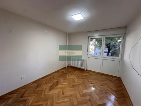 Empty room with wooden parquet flooring and a window. - image 9