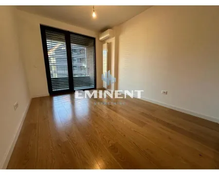 Empty room with wooden flooring and access to the terrace. - image 10