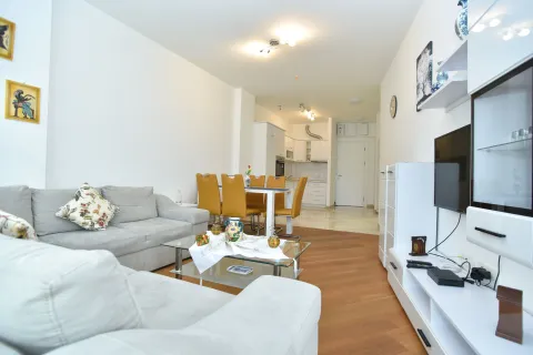 Spacious living room with a sofa set, dining area, and kitchen in the background. - image 2