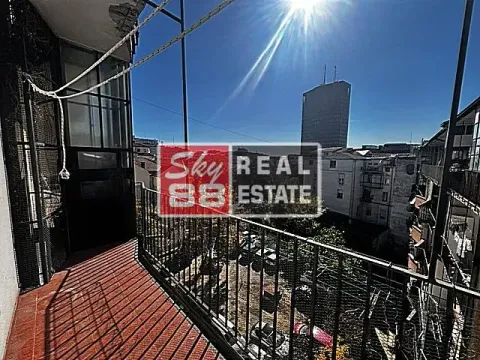 Balcony with a metal railing and city view. - image 15