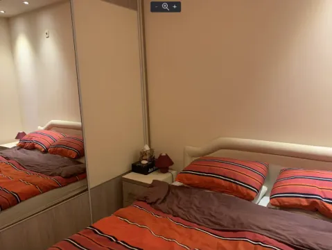 Bedroom with a double bed and a built-in wardrobe with a mirror. - image 11
