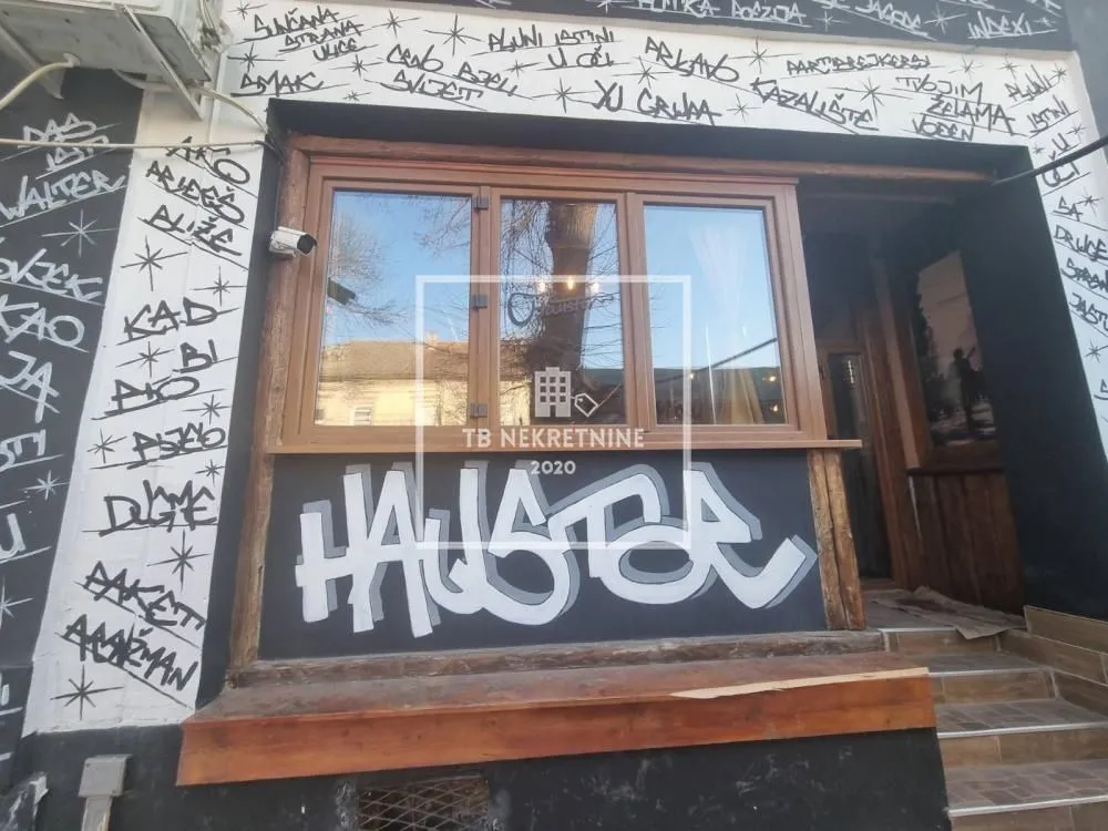 Exterior of a commercial space with graffiti on the facade.