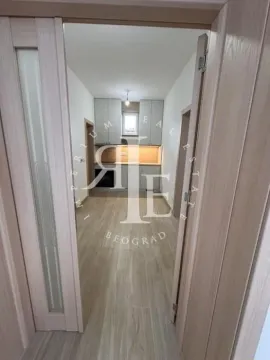 View from the hallway into the new kitchen with white cabinetry. - image 5
