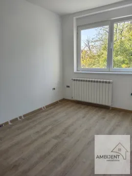Empty room with laminate flooring, white walls, and a window. - image 11