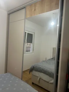 A bedroom with a large mirrored wardrobe and a bed. - image 5