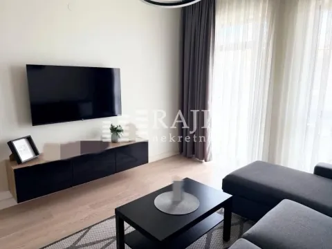 Modern living room with a sofa and television. - image 2