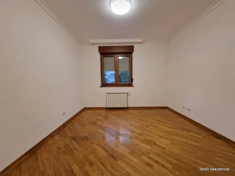 Empty room with parquet flooring and a window. - image 8