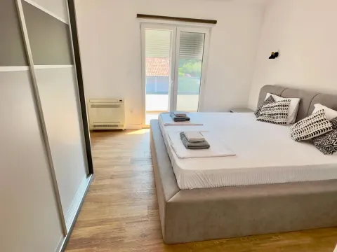 Bright bedroom with a double bed, wardrobe, and terrace access. - image 7