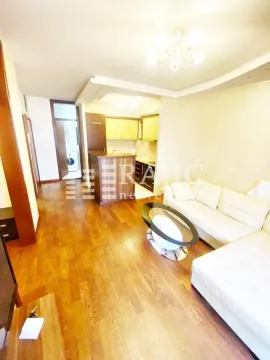 Living room with sofa and view towards the kitchen and hallway. - image 4