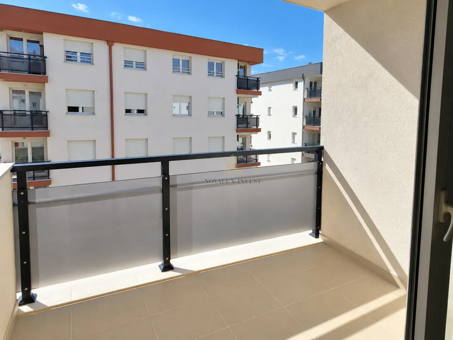 View from the balcony overlooking surrounding buildings and the neighborhood.