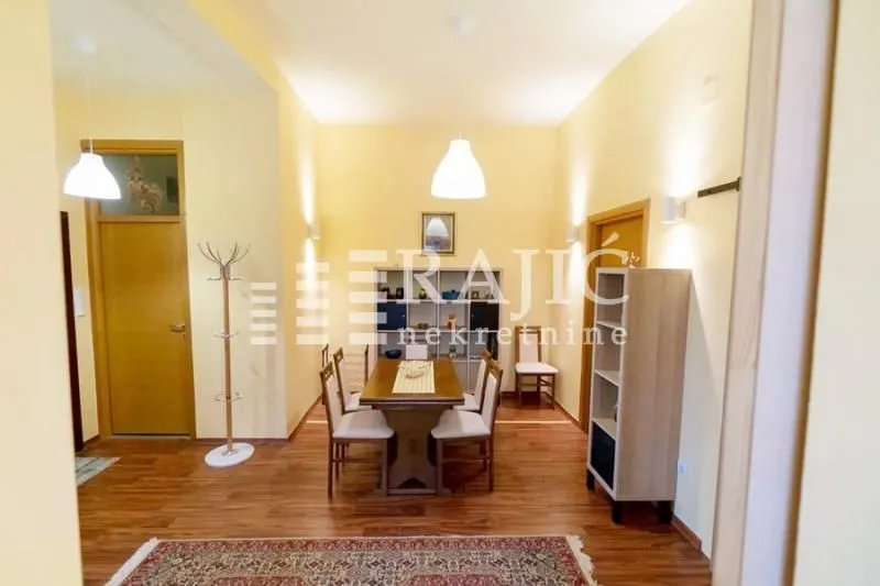 Spacious dining area with a wooden table and chairs.