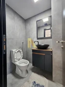 Modernly equipped bathroom with grey tiles and a black washbasin. - image 15