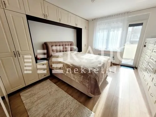 Furnished bedroom with a double bed, fitted wardrobes, and access to the terrace.