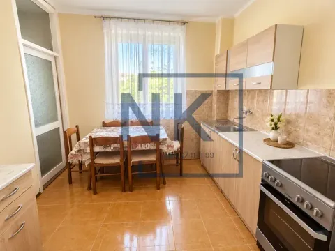 Kitchen with a dining area and wooden cabinetry. - image 3